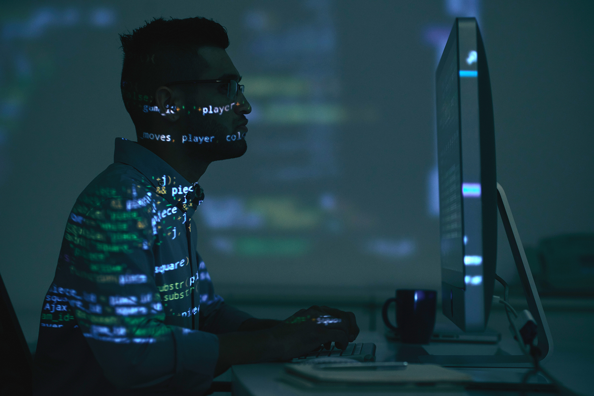 pic of guy in shadow using computer